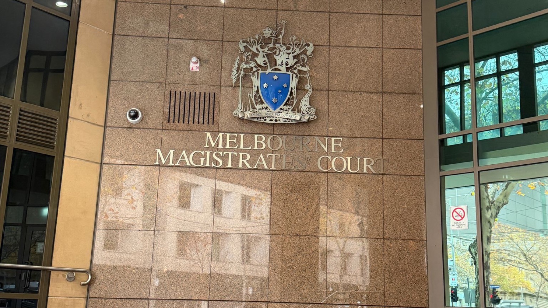 Signage and the Victorian coat of arms at the entrance to the Melbourne Magistrates' Court